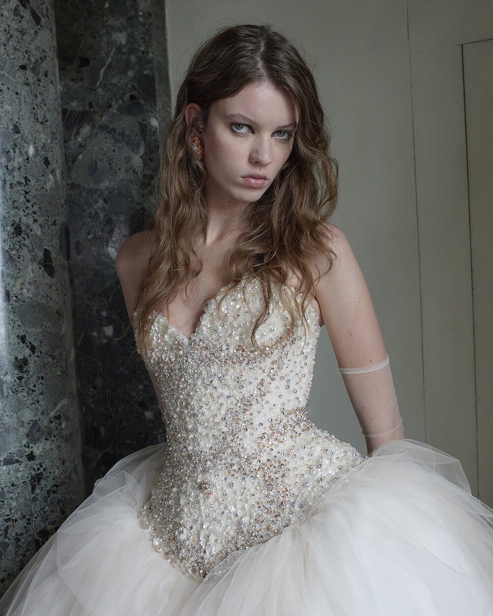 Close-up of the model’s face and Mariposa’s pearl-, sequin- and crystal-embellished bridal corset.