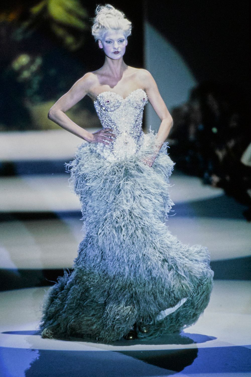 Linda Evangelista on the runway in Vivienne Westwood’s Queen of Sheba gown, with a sculpted jewelled corset and a full feathered skirt.